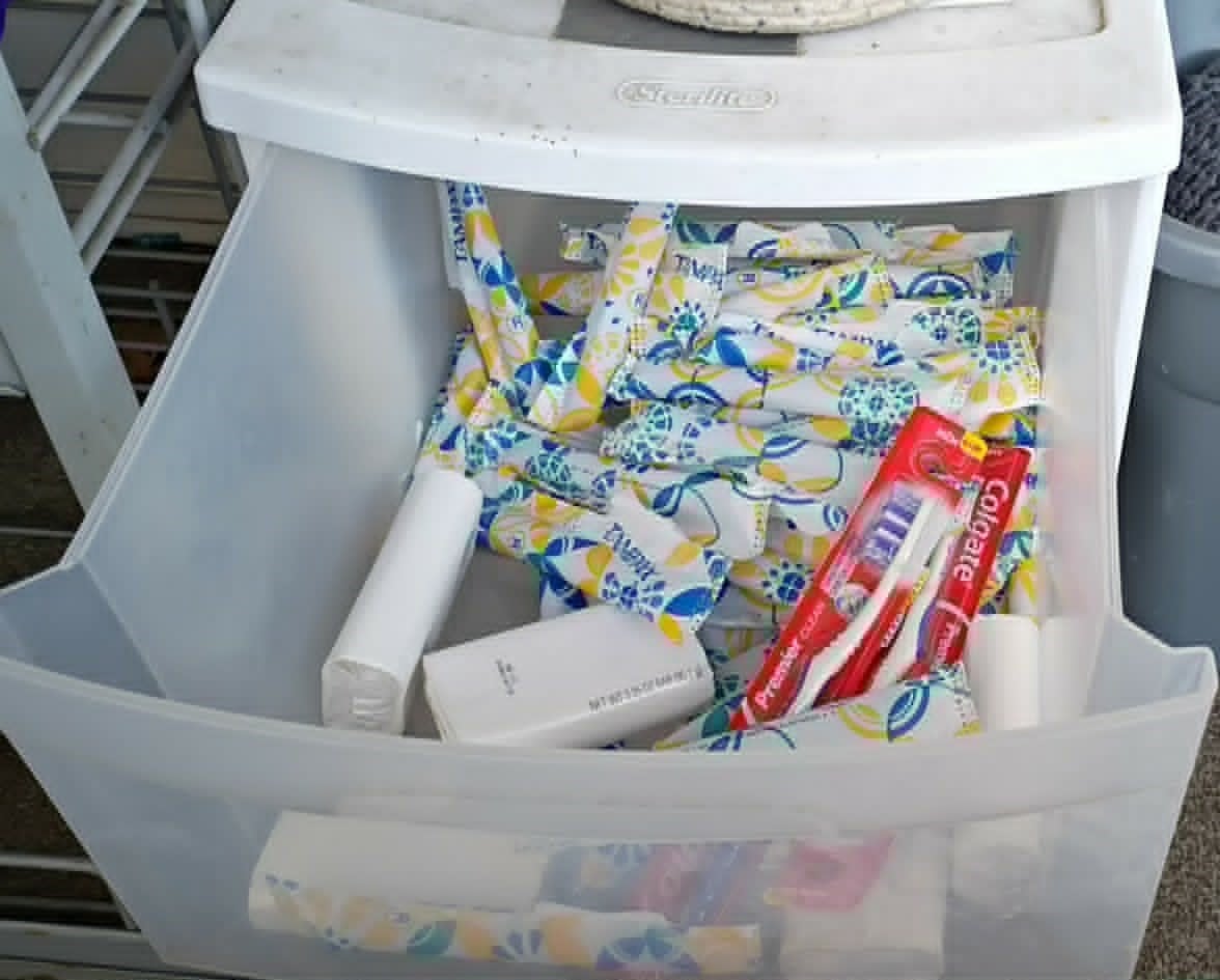 A drawer of hygiene supplies including toothbrushes, soap, and feminine products on the Community Porch in Hoosick Falls NY