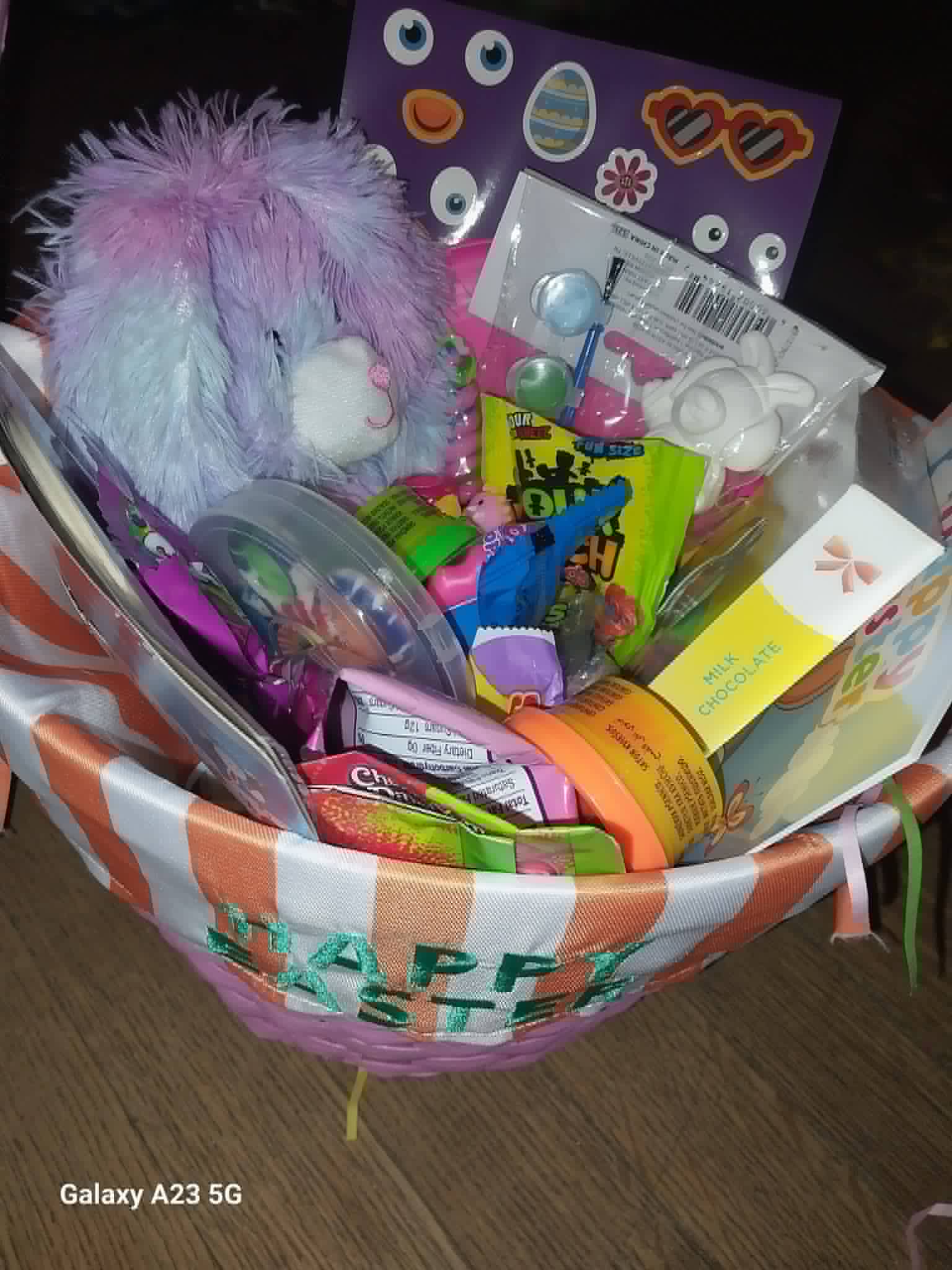 A Happy Easter basket with a plush bunny, candy, and toys from the Community Porch Easter program in Hoosick Falls NY