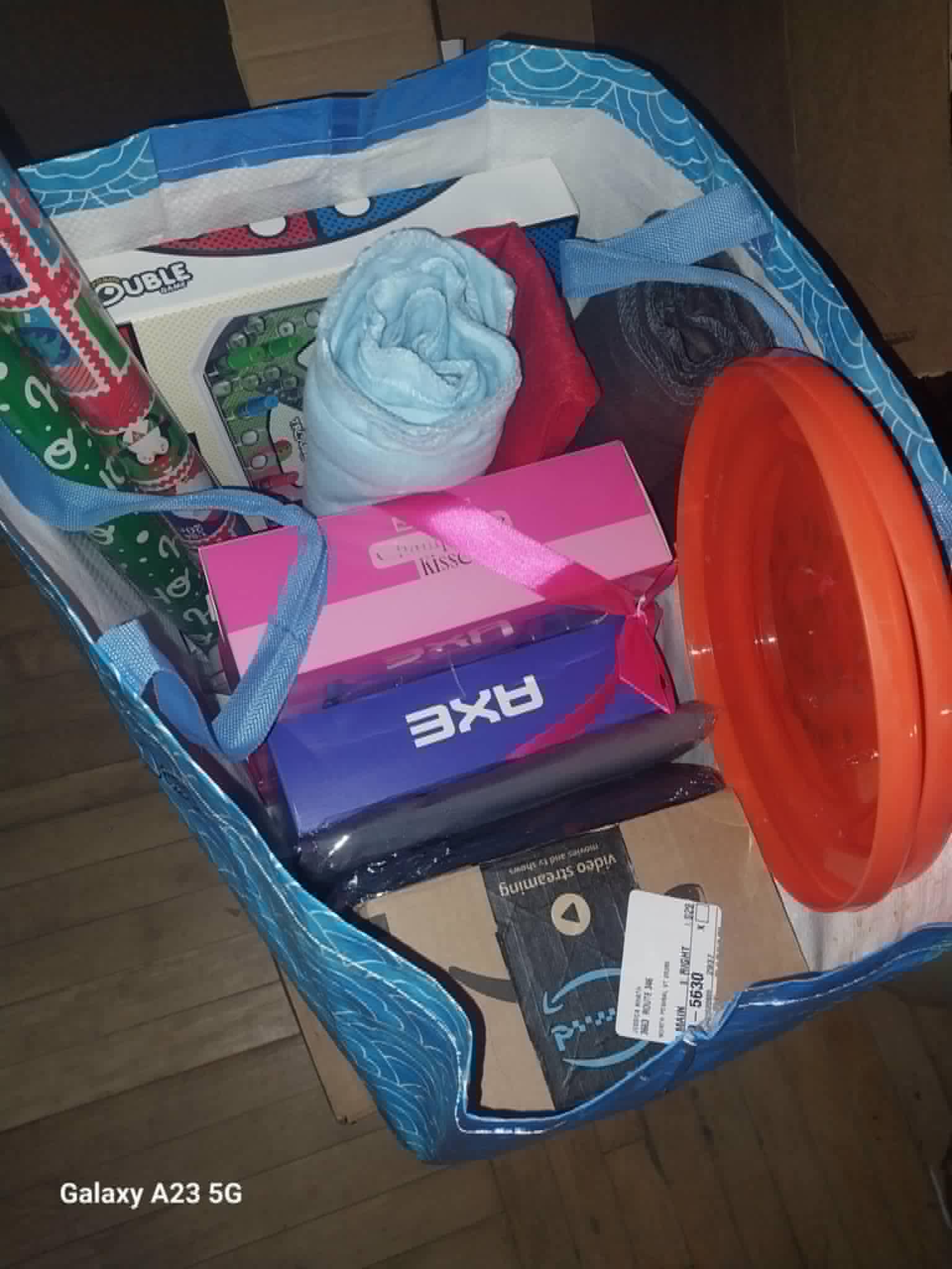 A tote of Christmas gifts including a board game and blanket for the Community Porch in Hoosick Falls NY