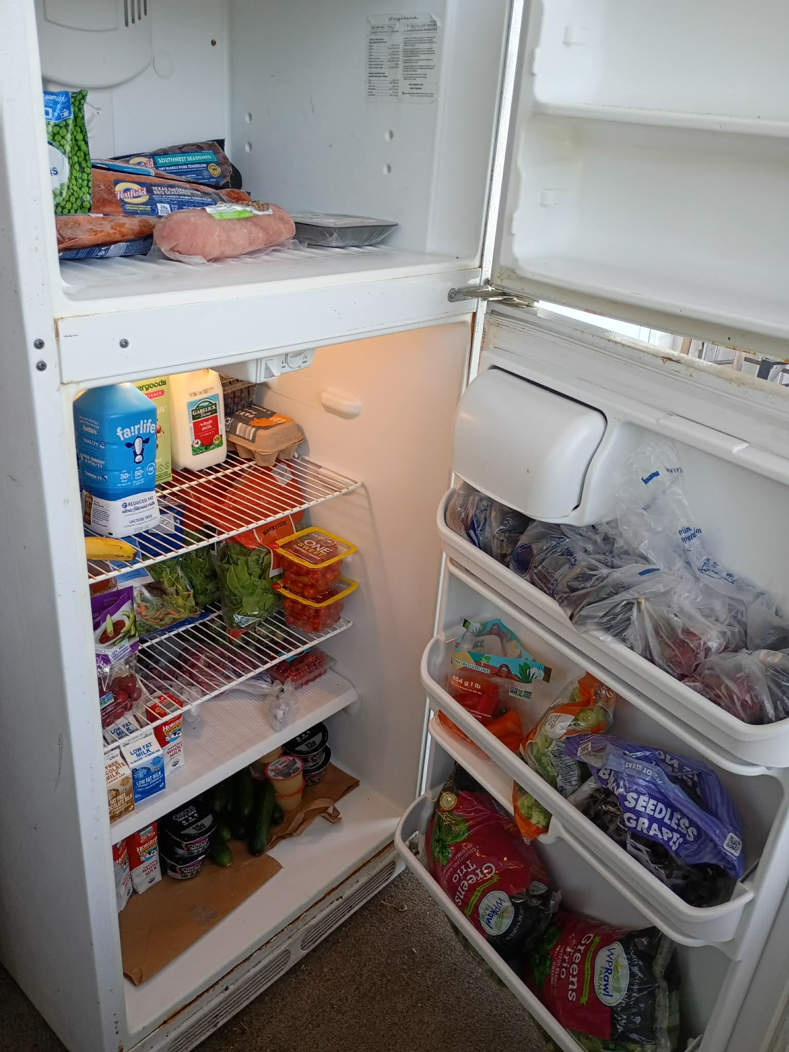 The refrigerator and freezer on the Community Porch in Hoosick Falls NY stocked with fresh and frozen food