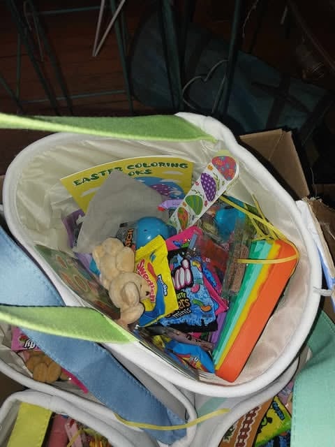 An Easter basket with coloring books, candy, and a plush bunny from the Community Porch in Hoosick Falls NY