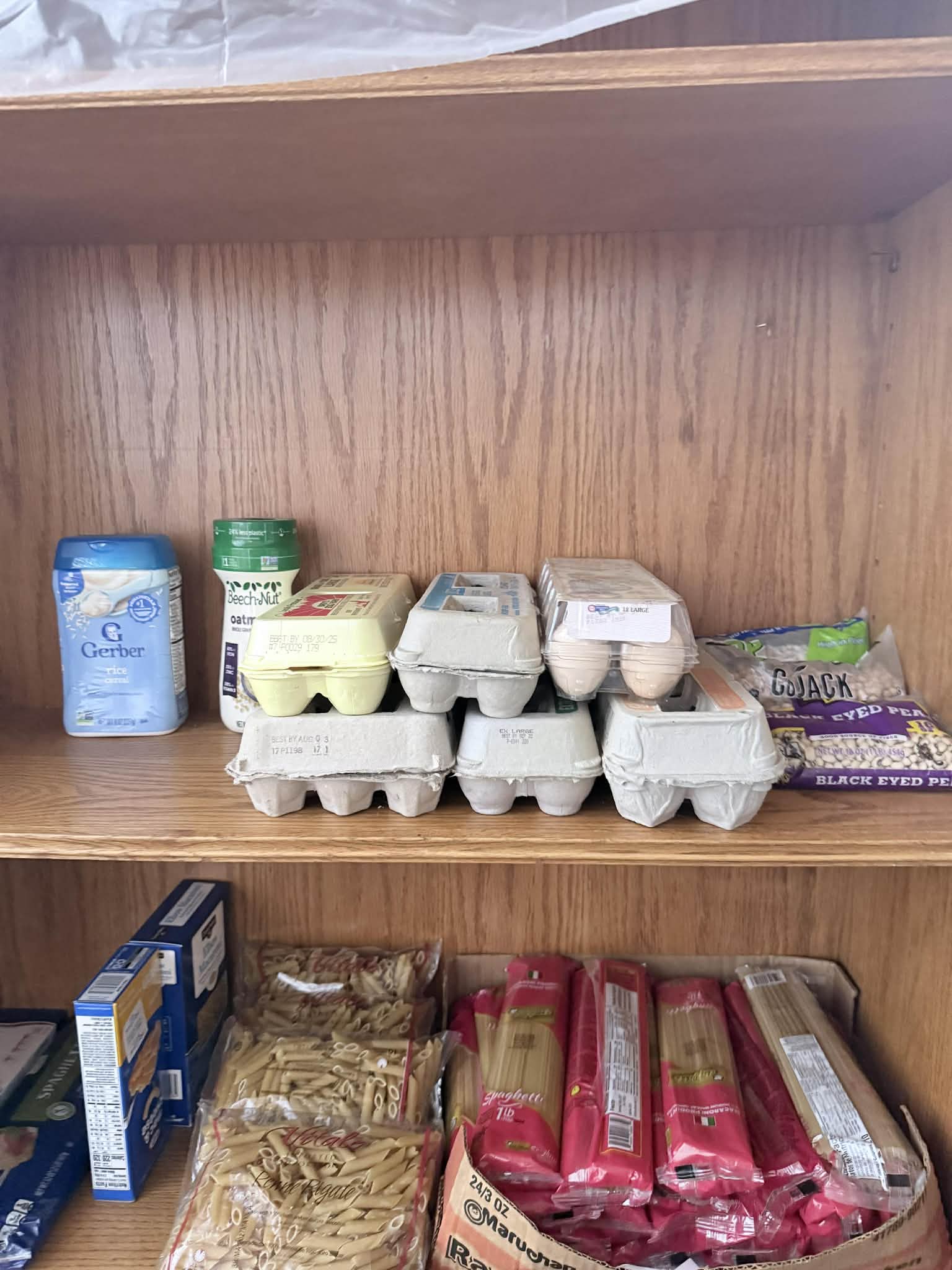 Community Porch shelves in Hoosick Falls NY stocked with fresh eggs, baby cereal, pasta, and dried beans