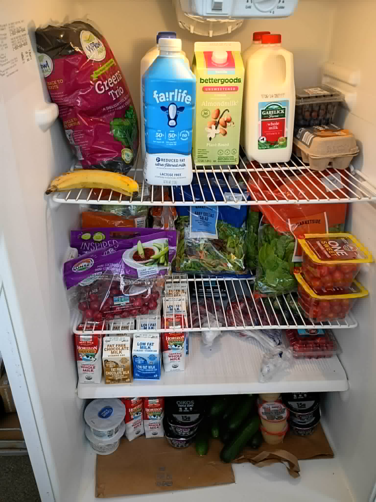 A Community Porch refrigerator in Hoosick Falls NY filled with milk, eggs, salads, and fresh produce