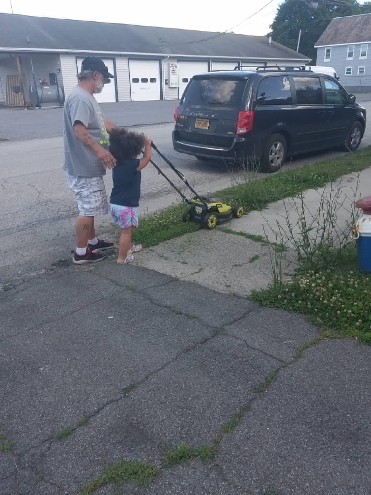 A neighbor and a child working together near the Community Porch in Hoosick Falls NY