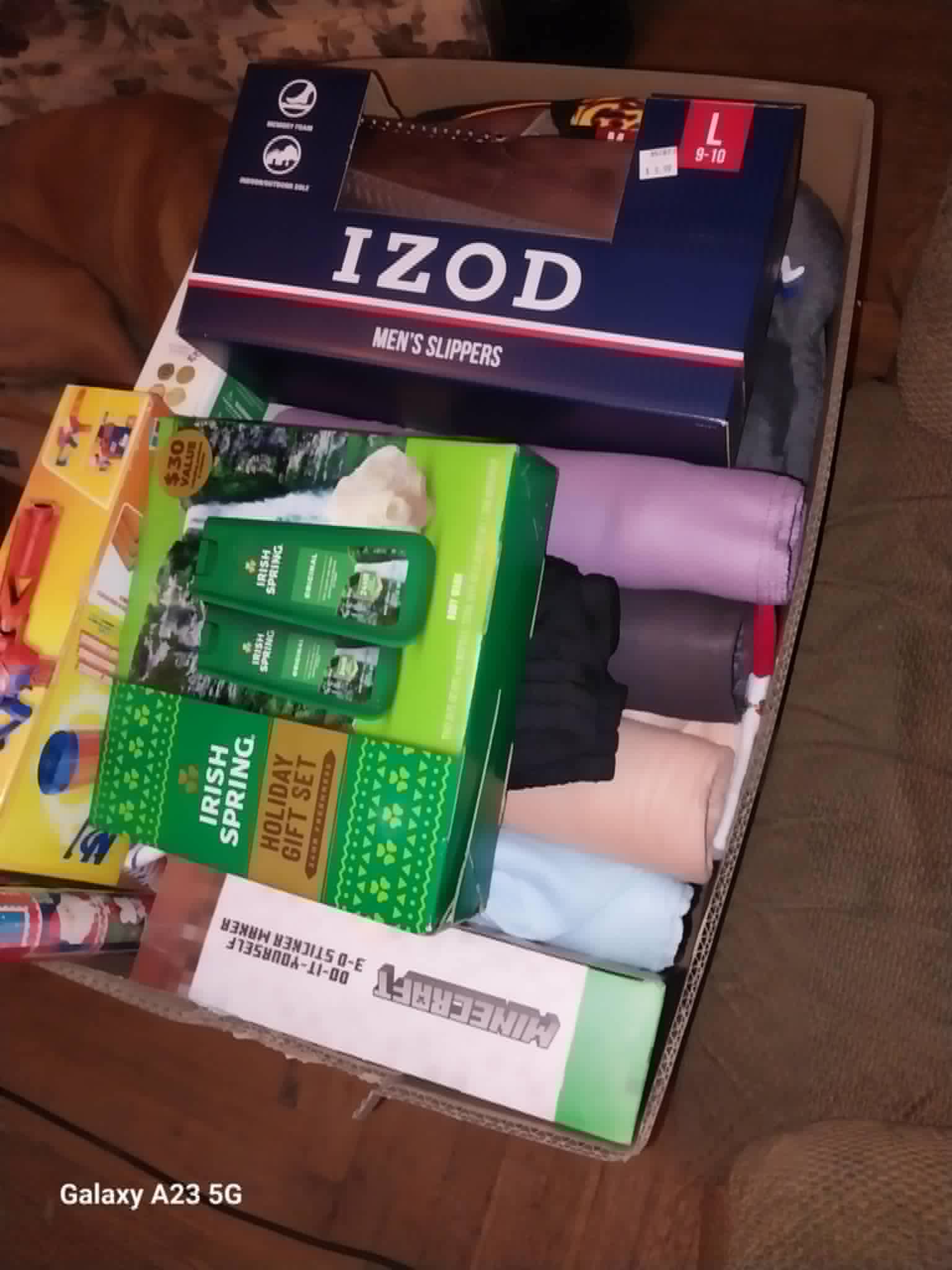 A box of Christmas gifts including slippers and toys for the Community Porch in Hoosick Falls NY