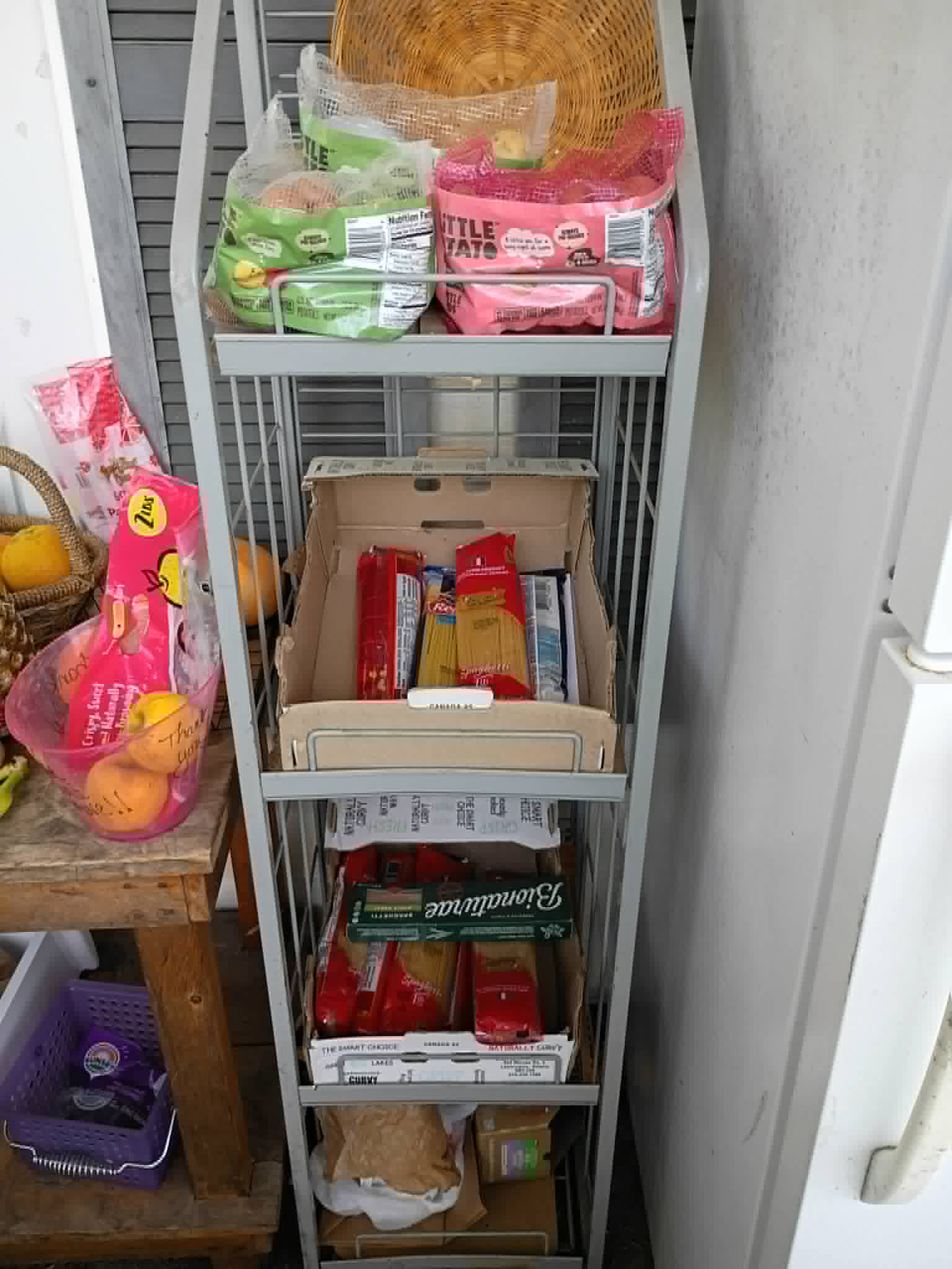 A shelving rack of bagged produce and dry goods on the Community Porch in Hoosick Falls NY
