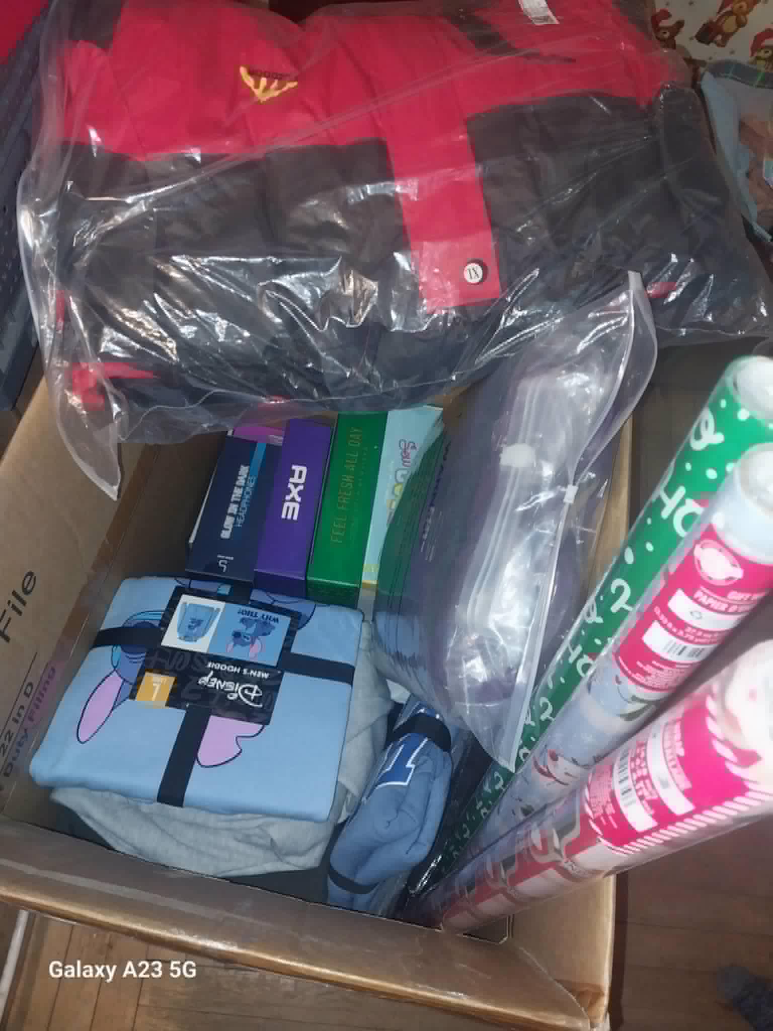 A box of Christmas gifts including a duffel bag and hoodie for the Community Porch in Hoosick Falls NY