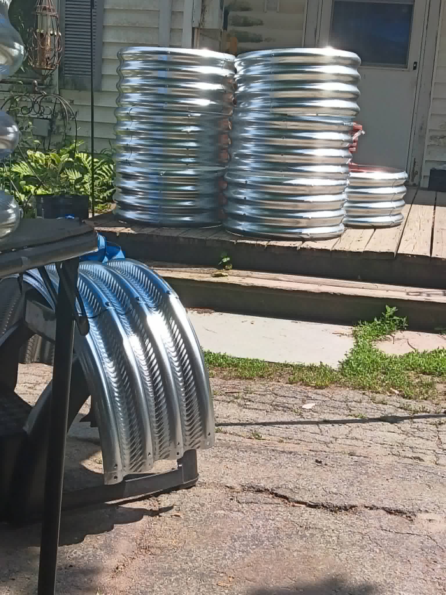 Stacks of new galvanized raised bed kits and a pile of delivered soil for the Community Porch Grow and Share program in Hoosick Falls NY