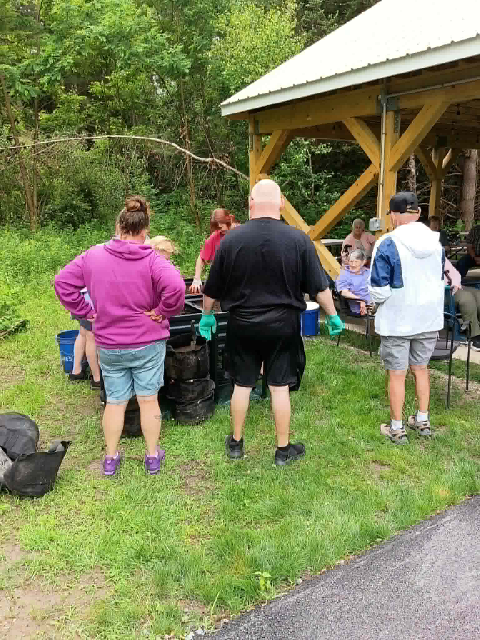 A group of volunteers and senior center residents gathered around new raised beds on garden day for the Community Porch Grow and Share program near Hoosick Falls NY